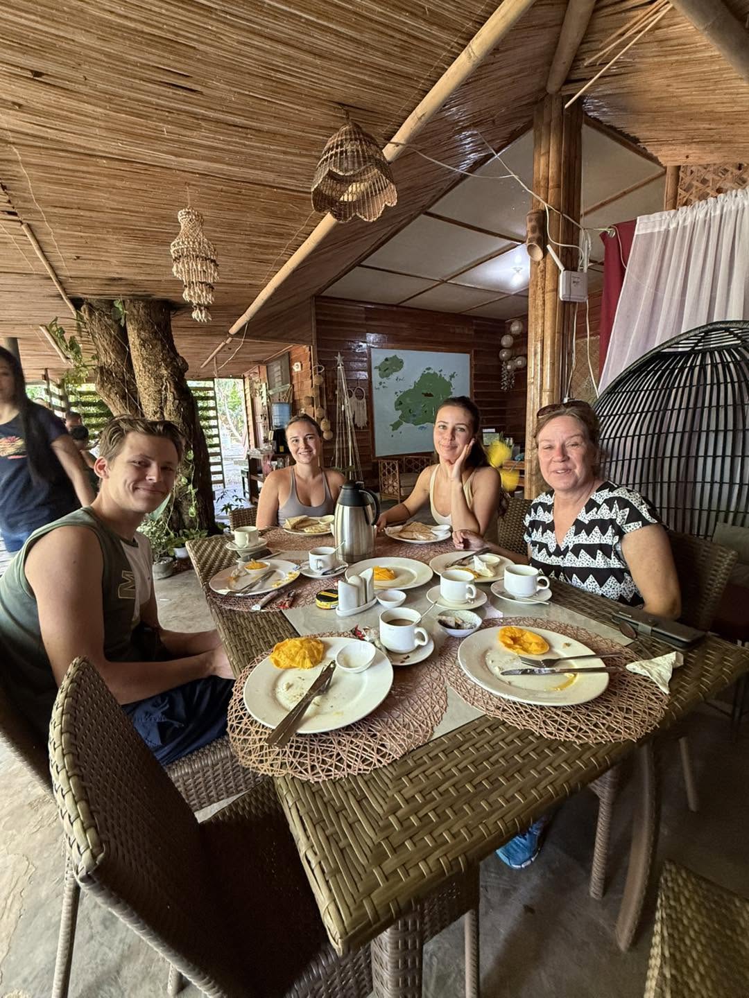 Guests sharing breakfast in the bamboo dining pavilion