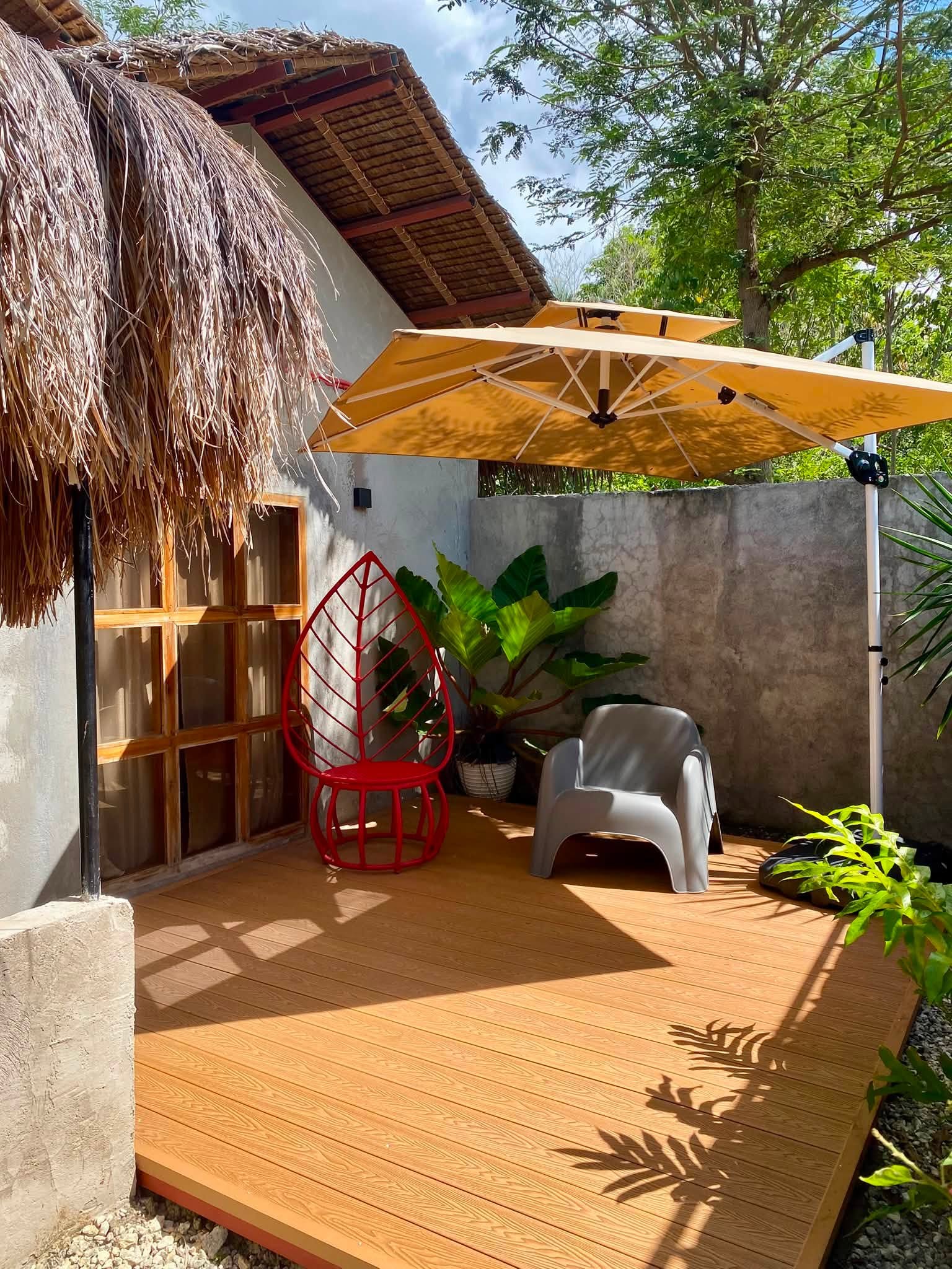 Wooden deck patio with umbrella outside a guest cottage