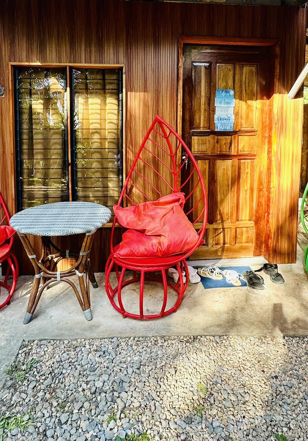 Cottage entrance with a red accent chair