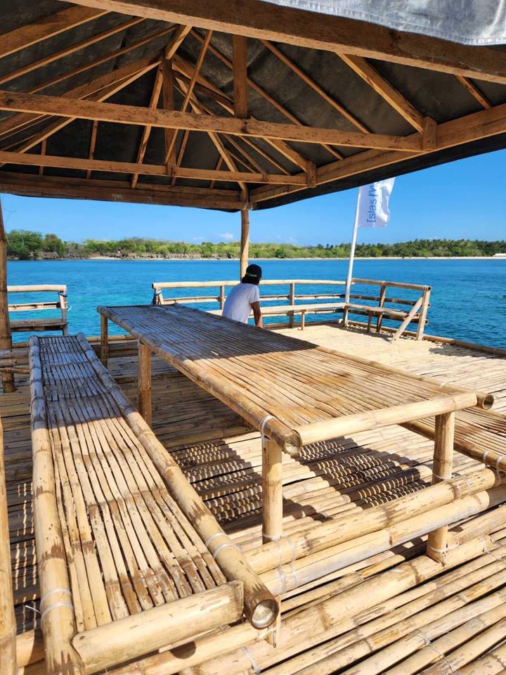 The covered bamboo raft on turquoise water