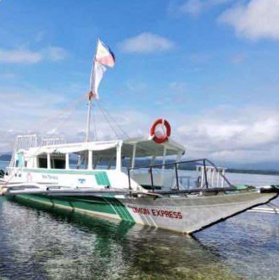 M/V Omon Express, a large outrigger boat with a covered deck, life ring and Philippine flag