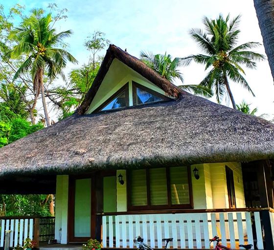 The thatched Luxury Kubo with its white-railed veranda