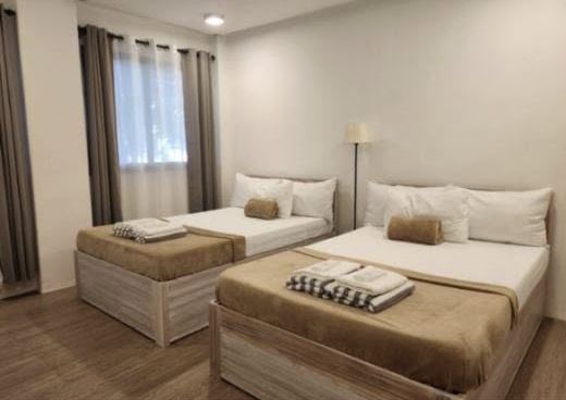 Superior Room: two twin beds with white linen, curtained windows and a floor lamp