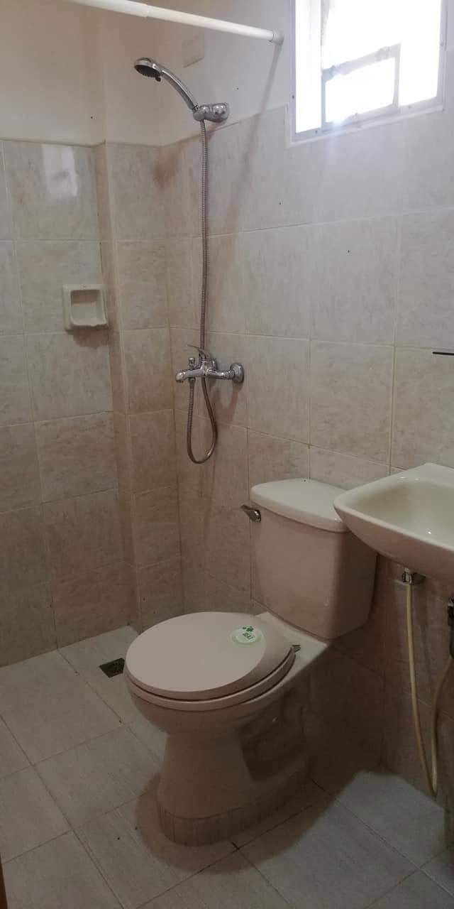 En-suite bathroom with hot shower at JD Beach Front Hotel