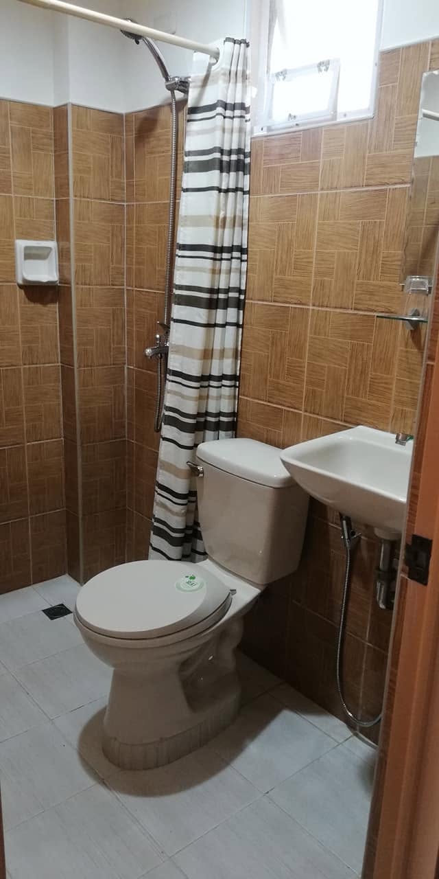 Clean private bathroom with shower at JD Beach Front Hotel