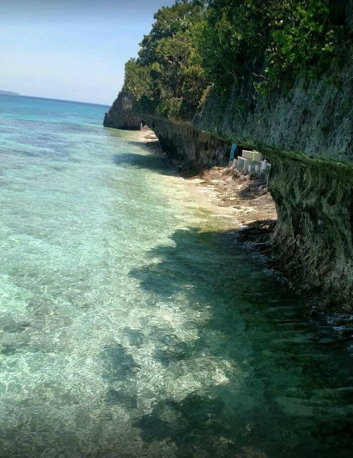 Clear shallow turquoise water along a limestone coast