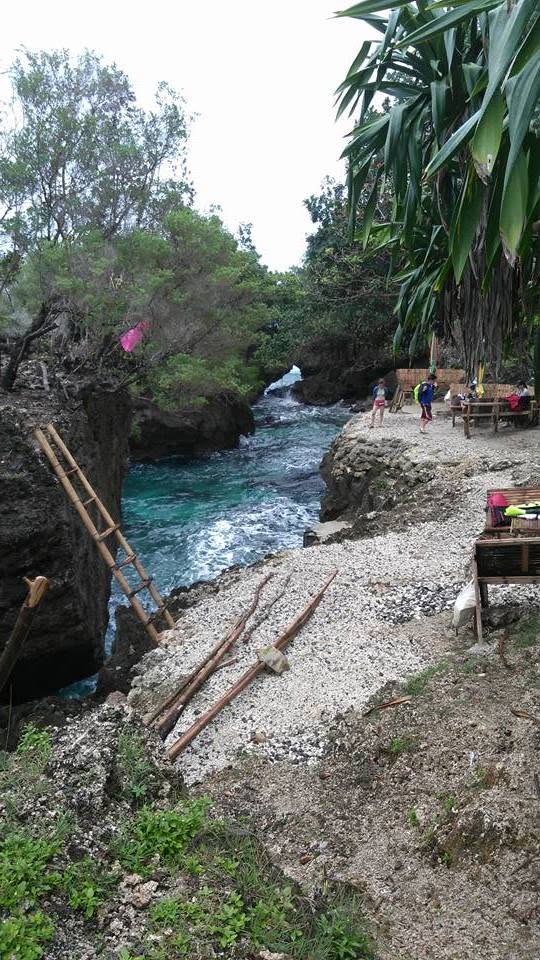 Rocky coastal cove with a narrow path and clear water