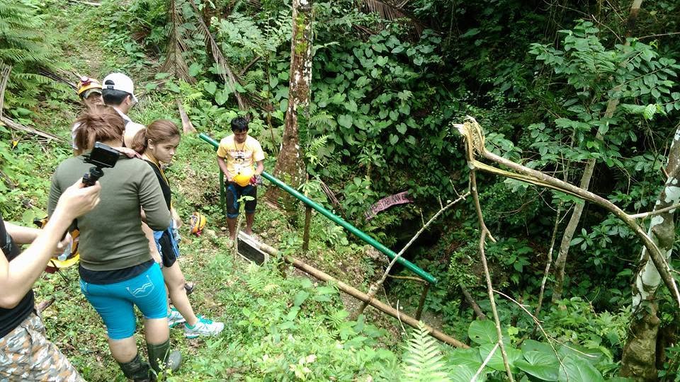 A group of trekkers walking through the forest on the way to a nearby cave