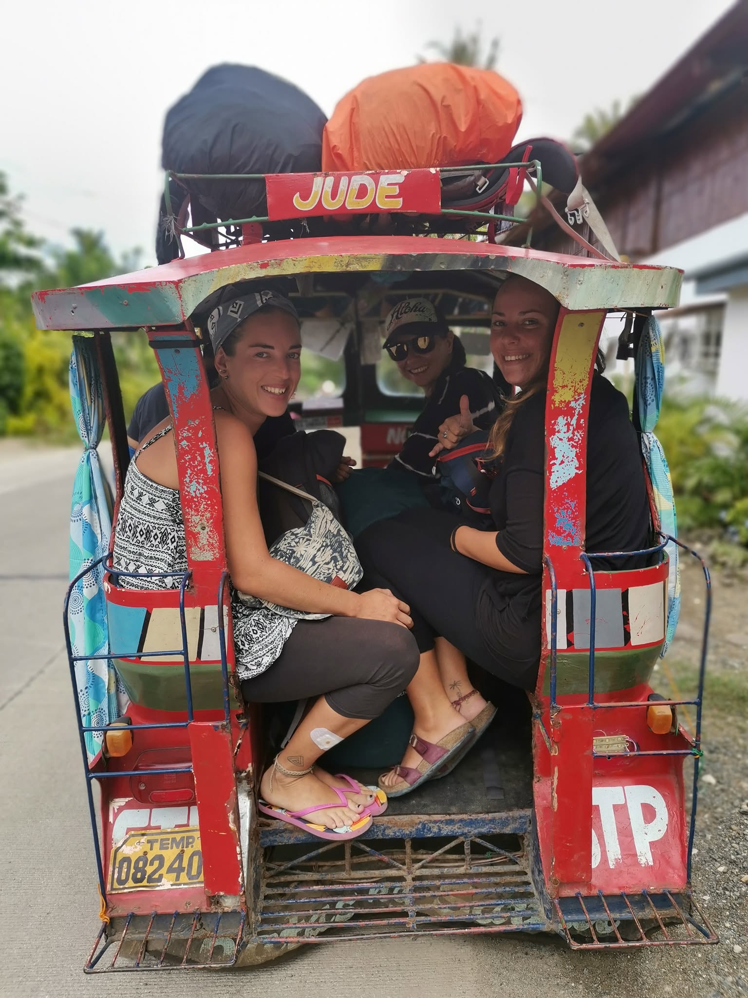 Guests riding a tricycle with luggage on the way to JD