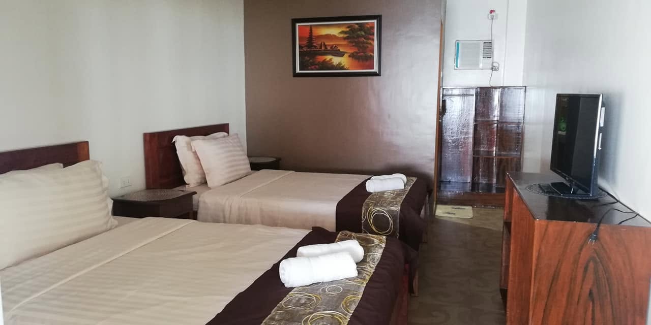 Twin-bed guest room at JD Beach Front Hotel