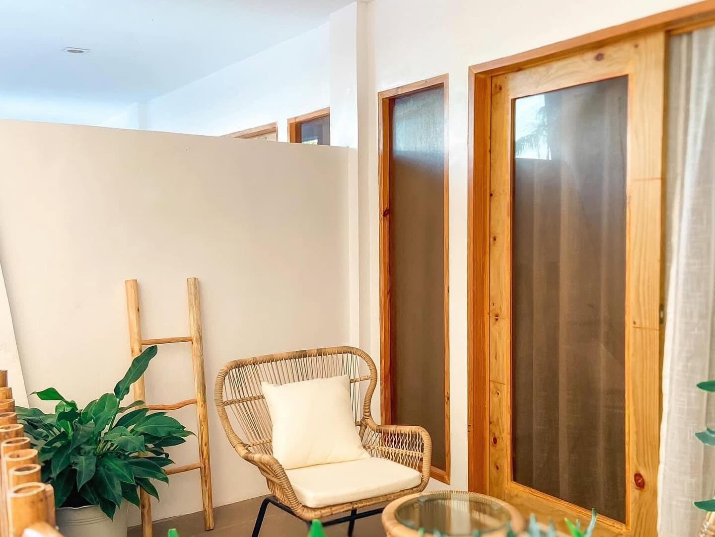 Lounge nook with a palm-leaf ceiling fan and white bench seating