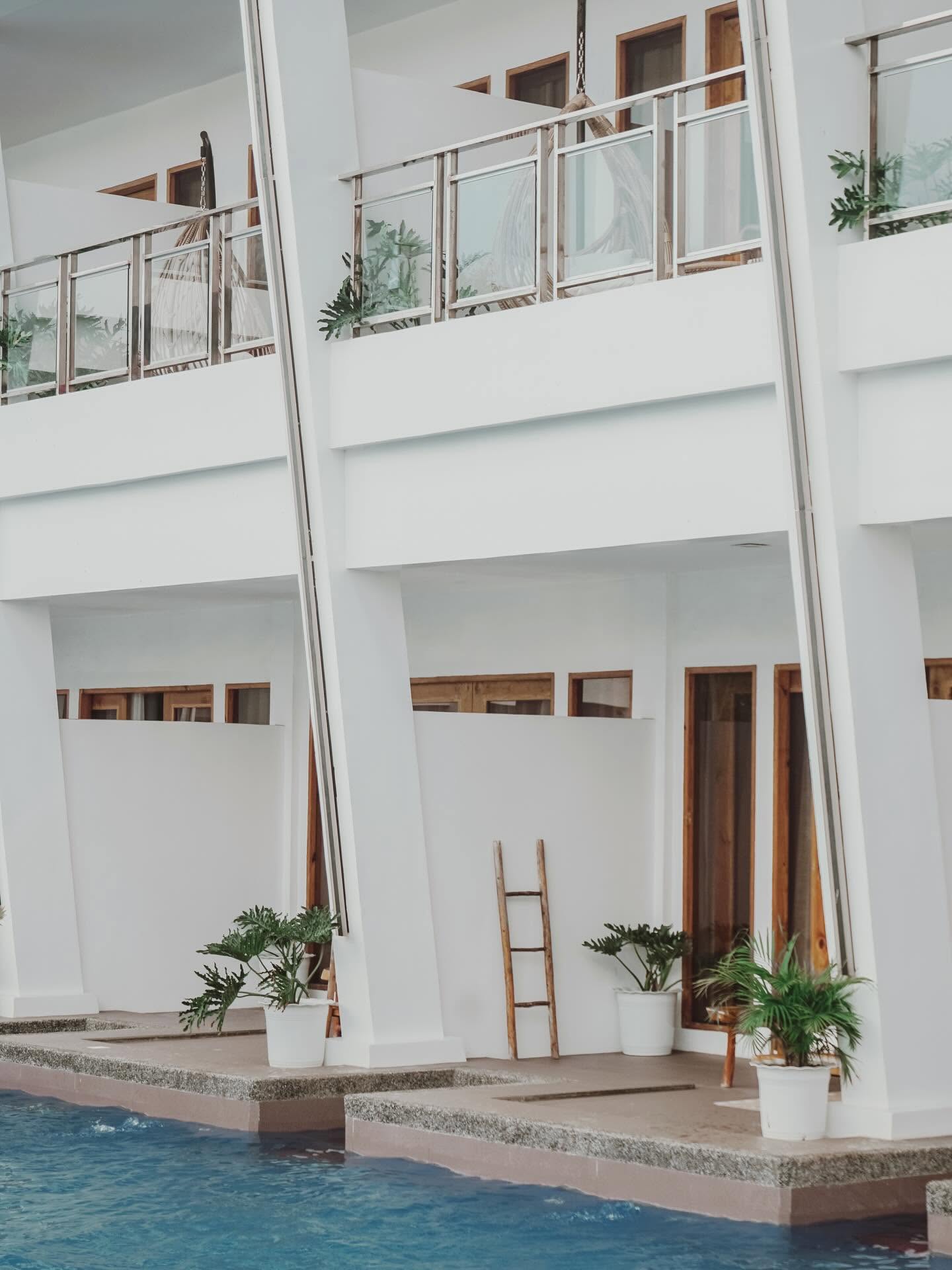 Balconies with hanging chairs above the pool