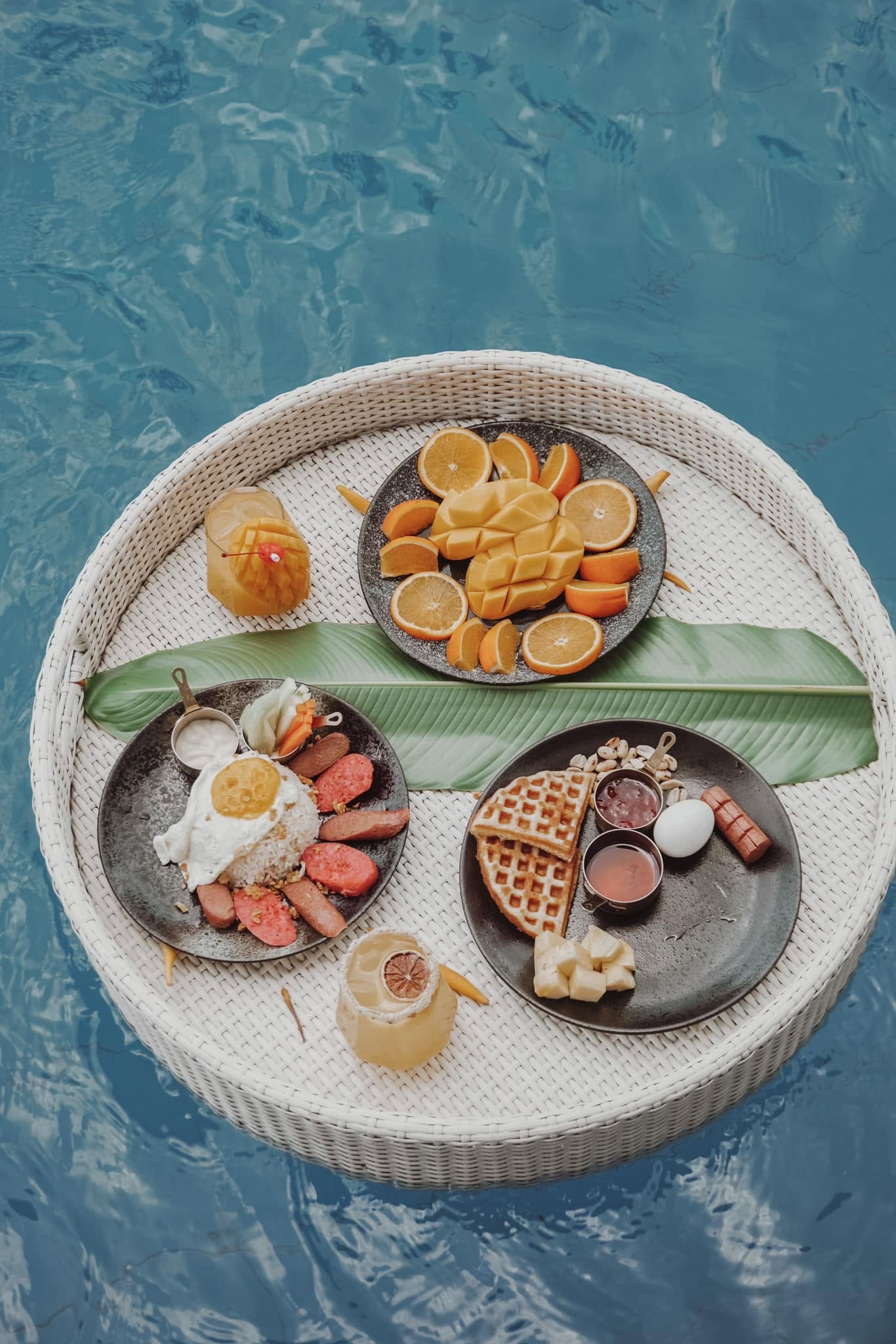 Cushioned daybed set beside the pool