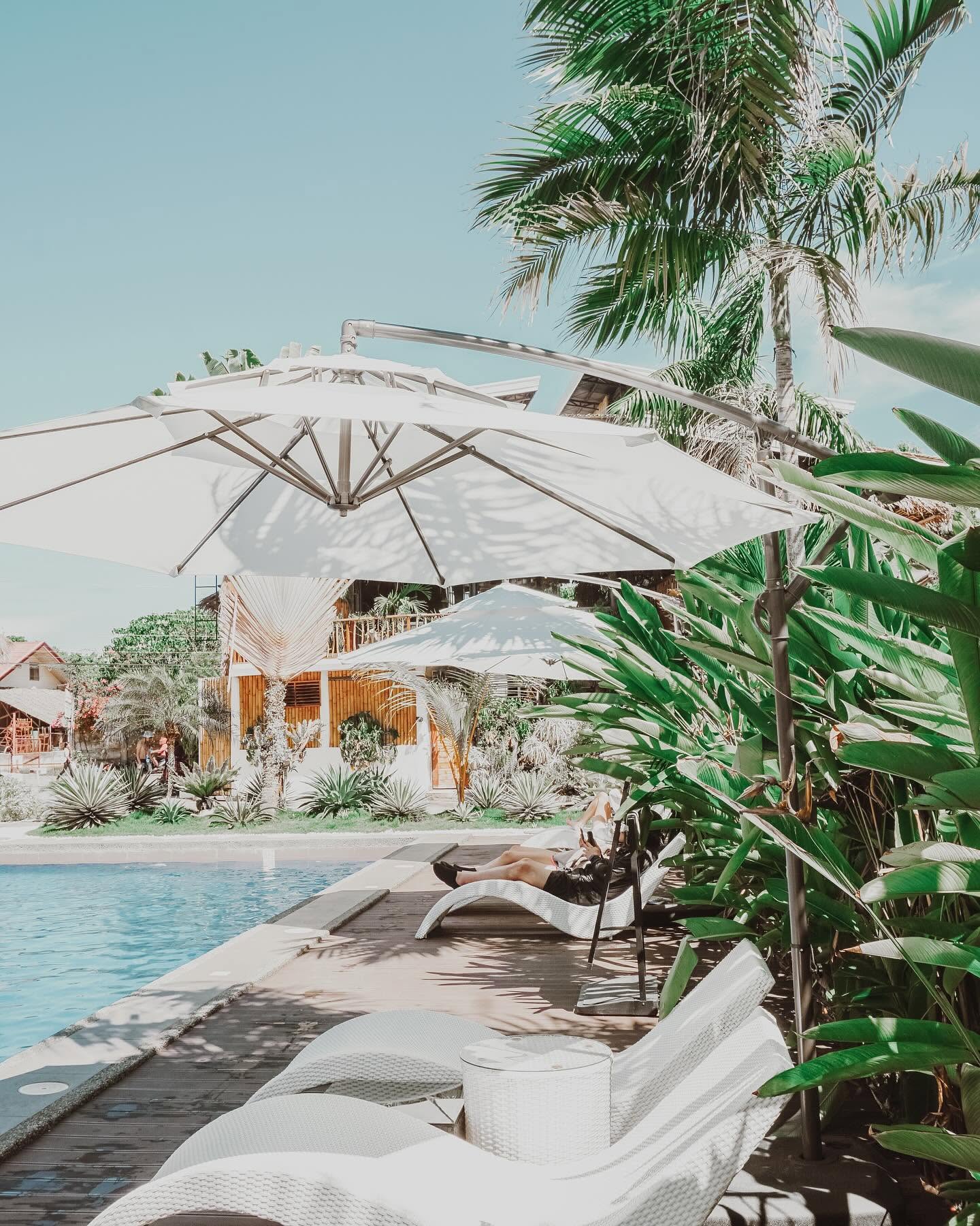 White wave loungers and umbrellas at the poolside