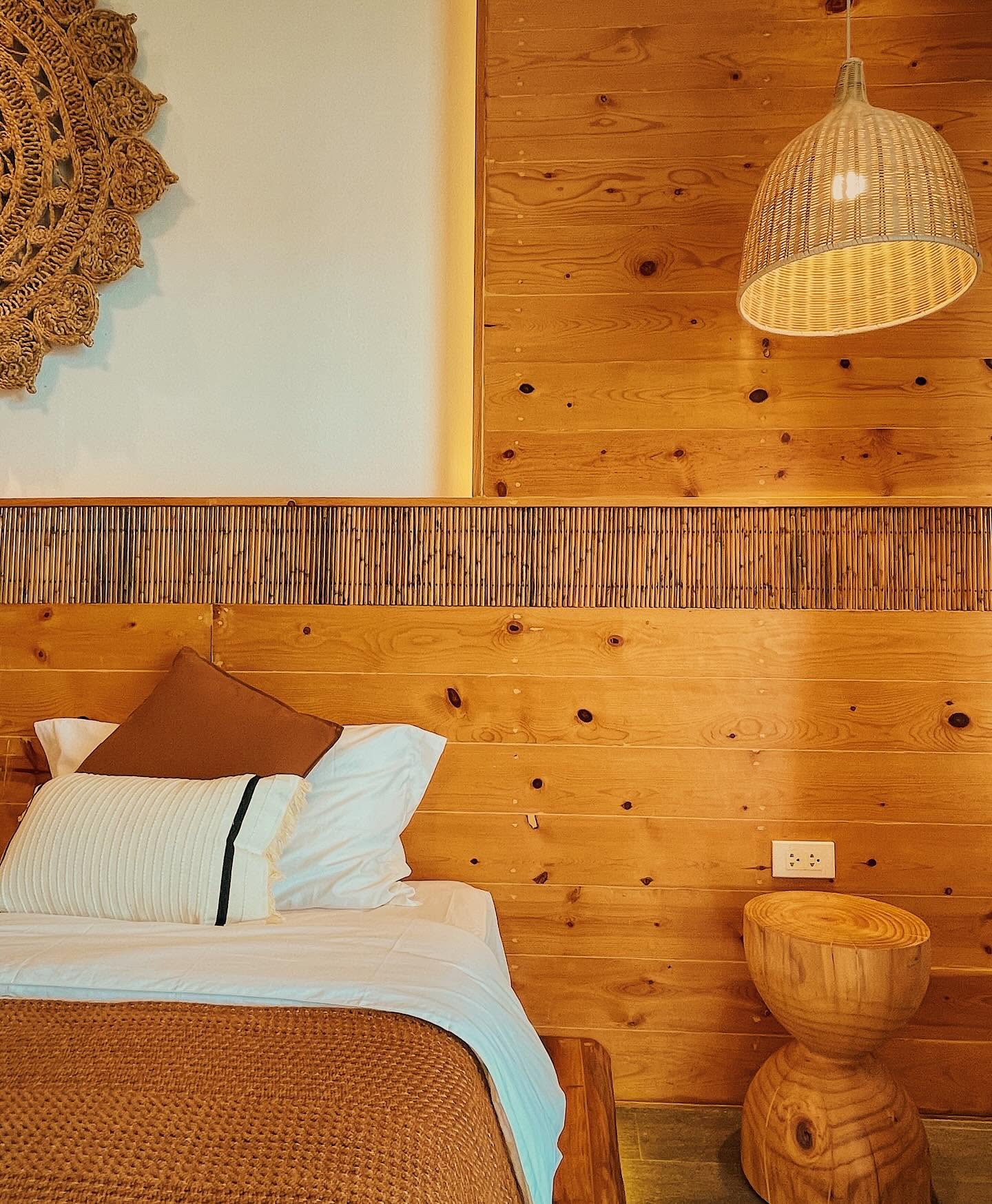 Woven headboard, bamboo trim and rattan pendant detail