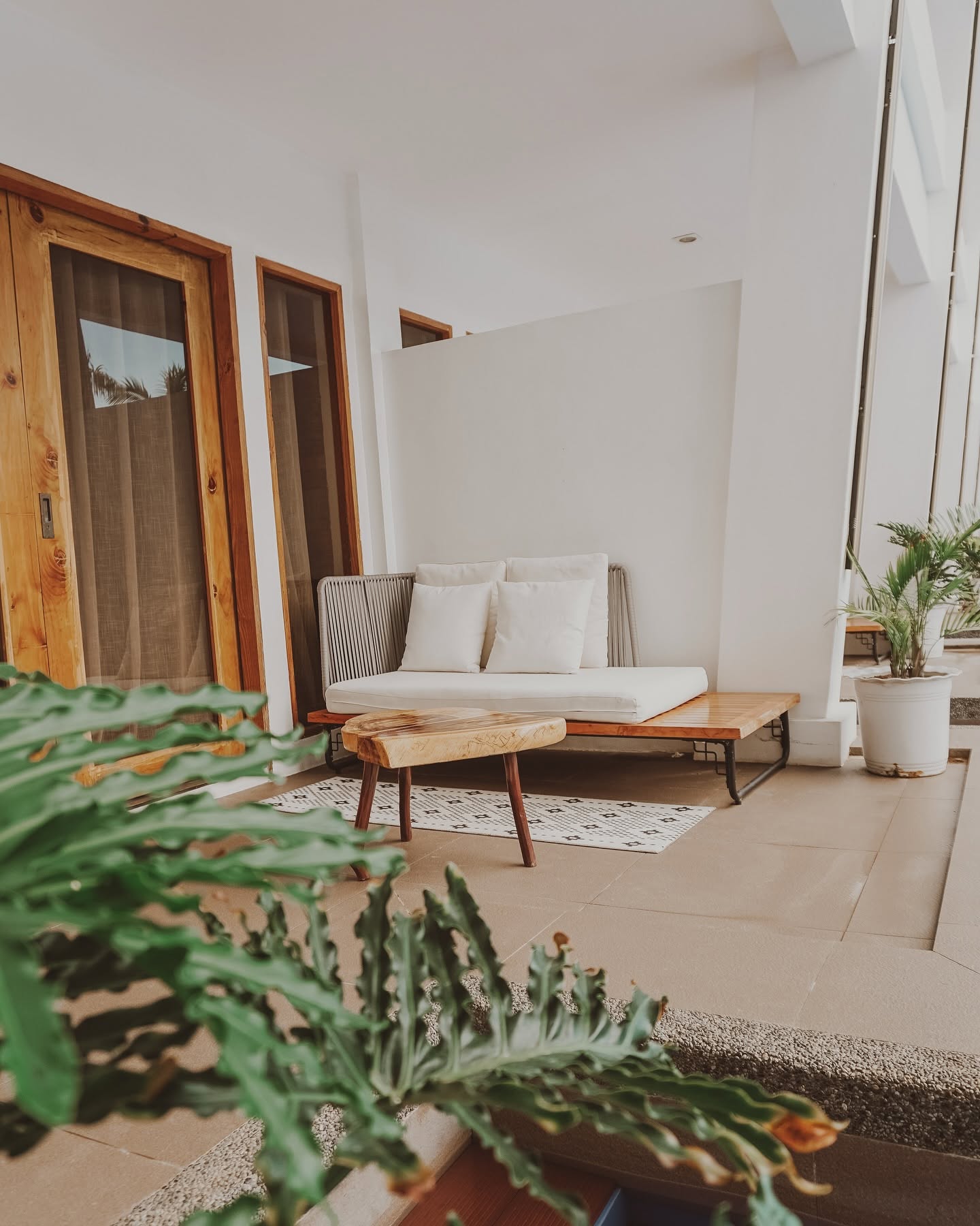 Cushioned daybed and live-edge table on a room patio