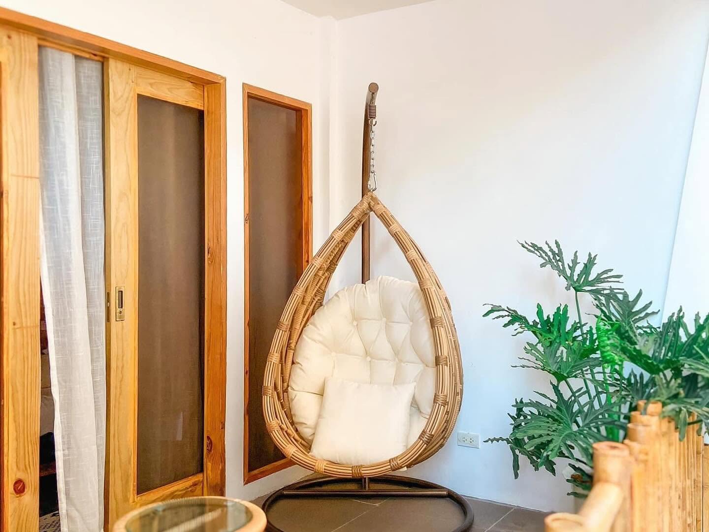 Rattan hanging egg chair in a room corner