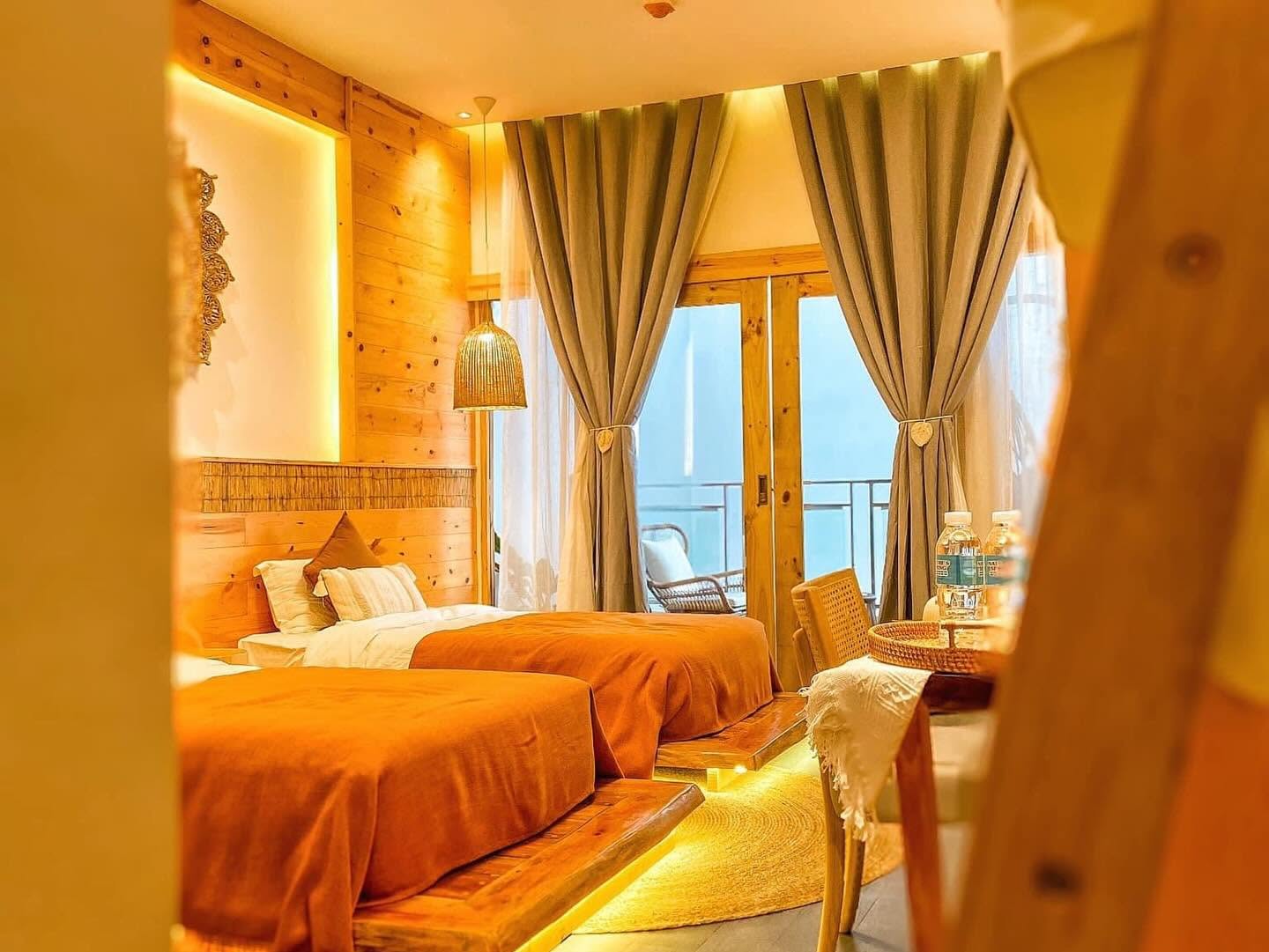 Twin beds with balcony doors in evening light