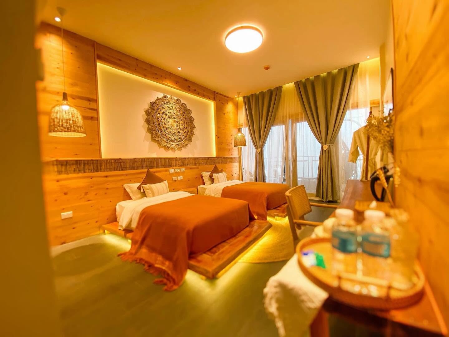Deluxe Twin Room with two beds, timber-panelled wall and woven mandala artwork