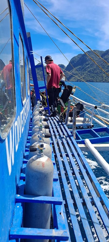 The W Divers Coron dive boat, with the shop name painted on the hull