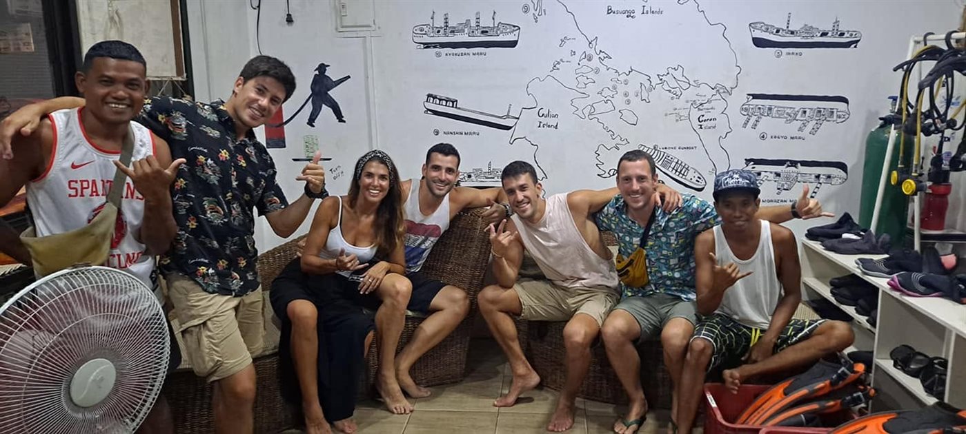 A mixed group of certified and non-certified divers relaxing at the W Divers Coron shop before a trip